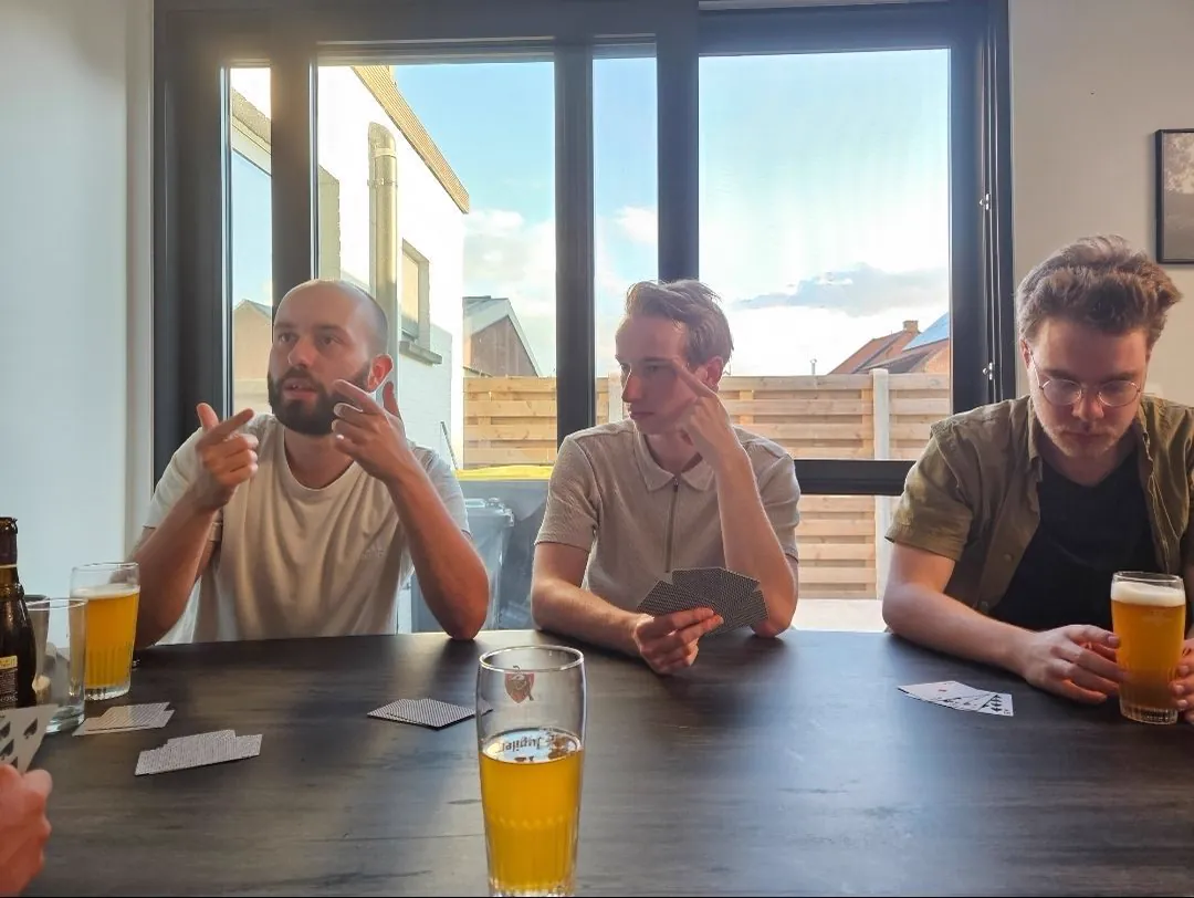 Team playing cards around a table